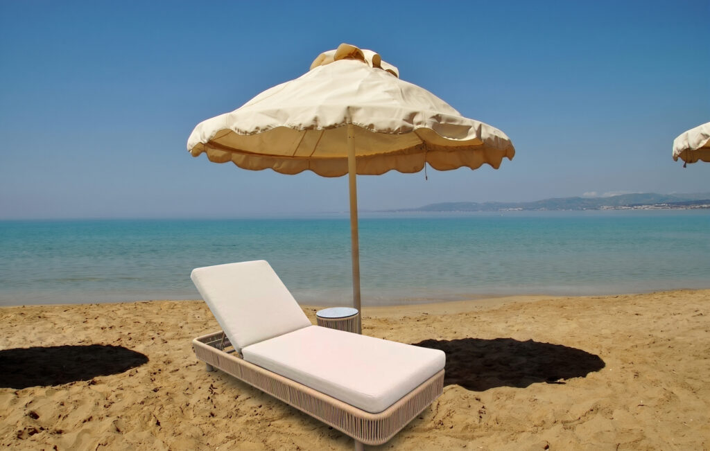 Laguna Premium luxury sun lounger on a sandy beach with cream parasol and turquoise sea