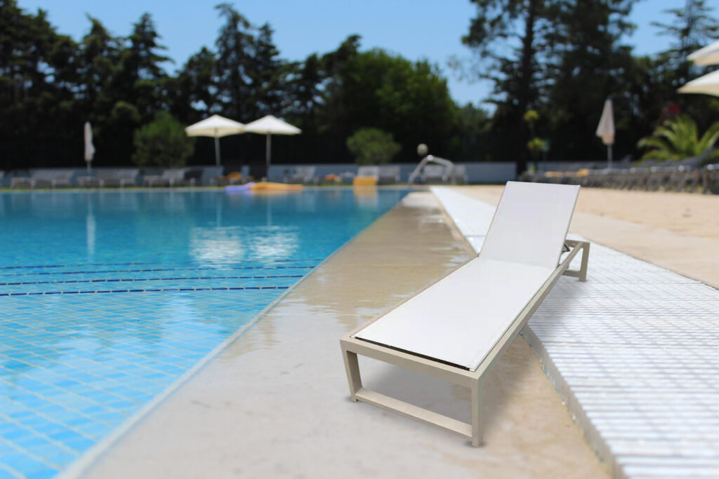 Marbella Essence white sun lounger for hotels beside a pool with clean minimal design