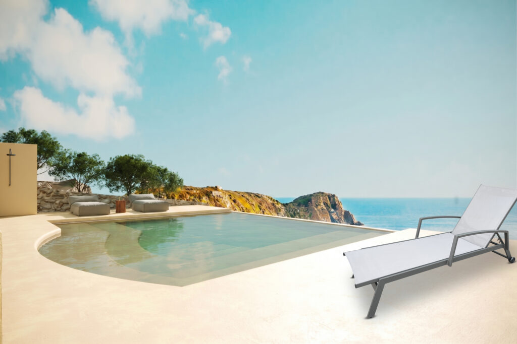 Positano Retreat sun lounger with armrests beside a luxury infinity pool and sea view