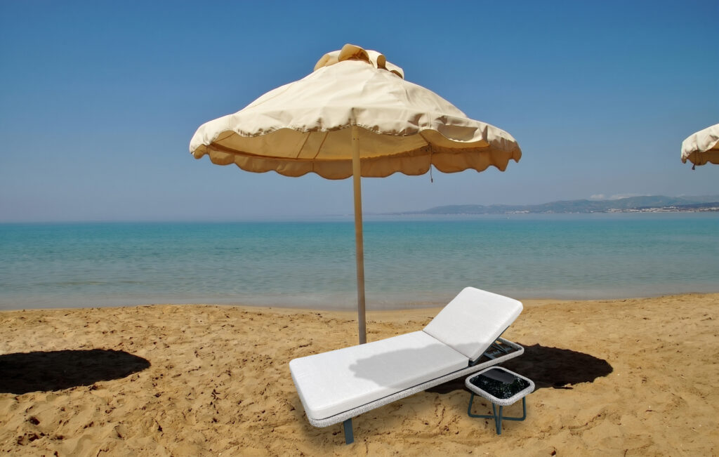 Santorini Serenity wide sun lounger for hotels on a sandy beach with cream parasol and turquoise sea