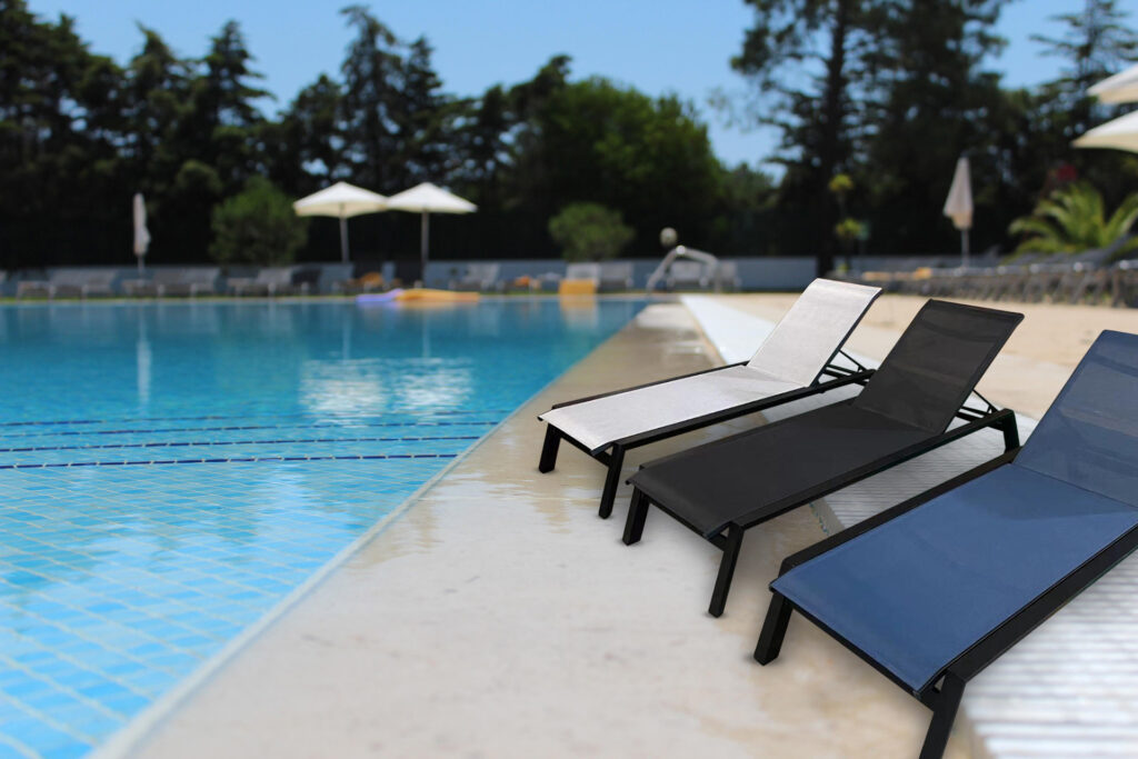 Valentina commercial sun lounger for hotels in three colours beside a hotel pool
