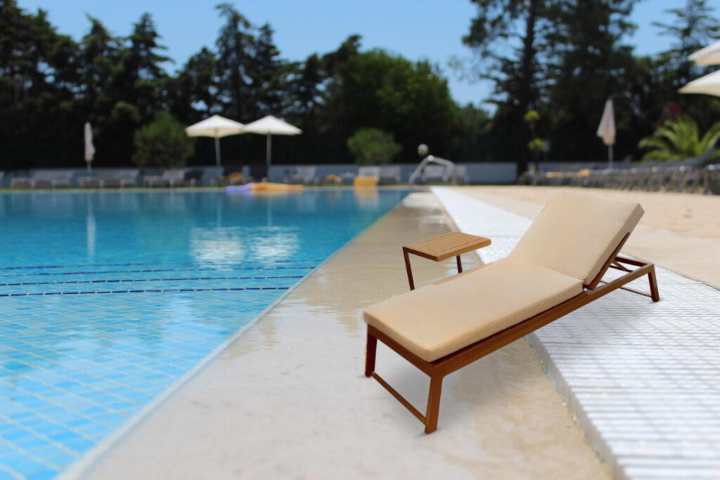 Verona Elite wood effect sun lounger beside a luxury hotel pool