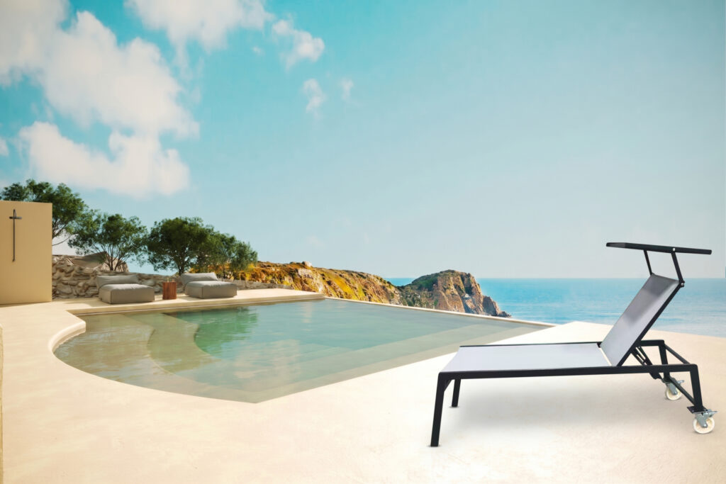 Unity Access accessible sun lounger with castor wheels beside a hotel pool